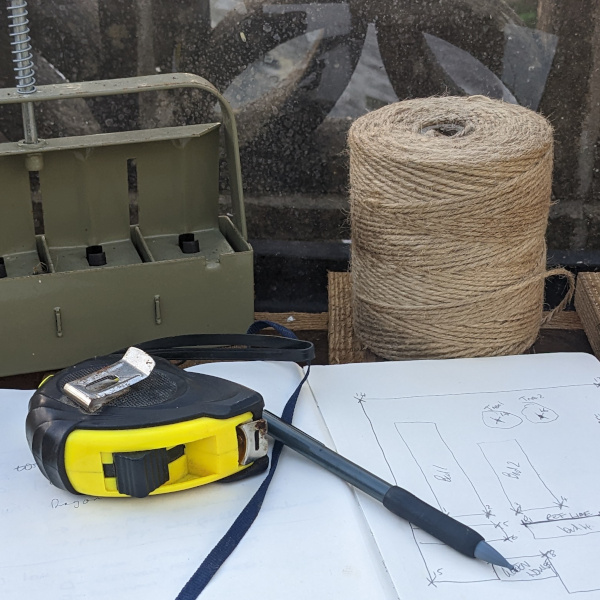 tape measure and string getting ready to measure out a garden